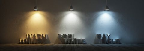 Warm white, cool white and daylight lamps lighting 3D text on a neutral wall