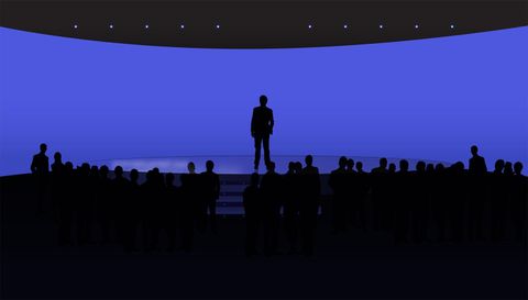 Graphic of a silhouetted speaker on a stage above a crowd against a blue backdrop