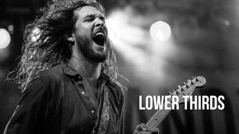 Black and white shot of a long-haired guitarist singing on stage, with Lower Thirds text overlaid